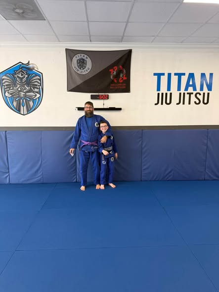 Titan youth student with an instructor after class