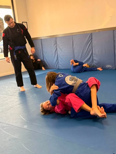 Titan Jiujitsu students drilling with a coach